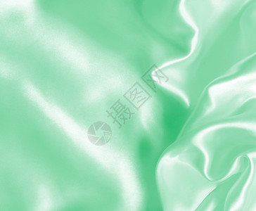 平滑优雅的绿色丝绸或纹质可用作背景缎纺织品布料图片
