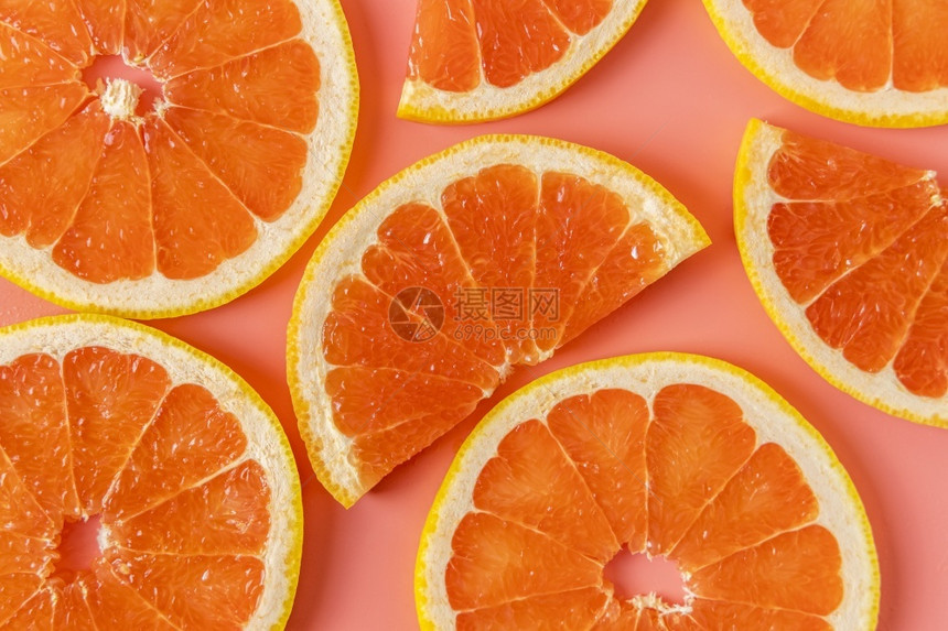 柑橘味热带粉红背景上新鲜有机葡萄树切片组平板地空间甜的图片