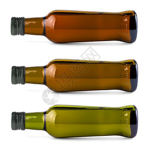 蔬菜套在侧瓶上白色橄榄油在侧绿色瓶上白橄榄油瓶子目的图片