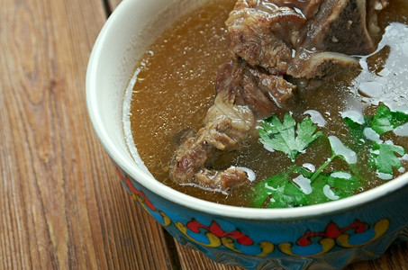 翘脚牛肉火鸡晚餐传统的Khash阿富汗亚美尼阿塞拜疆波斯尼亚和黑塞哥维纳保加利亚格鲁吉伊朗拉克和土耳其的煮熟牛角脚传统菜背景