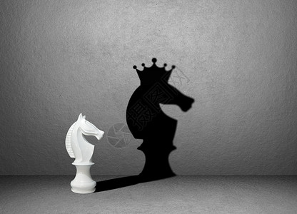 国际象棋马目标赢胜者概念墙上的象棋阴影征设计图片