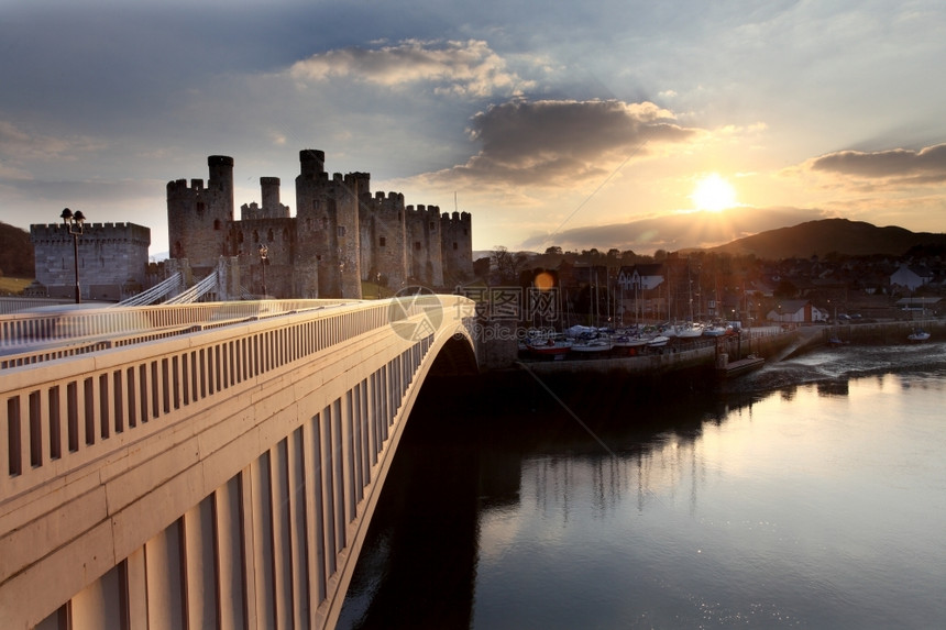 暮城垛联合王国北威尔士黄昏时的Conwy城堡反射图片