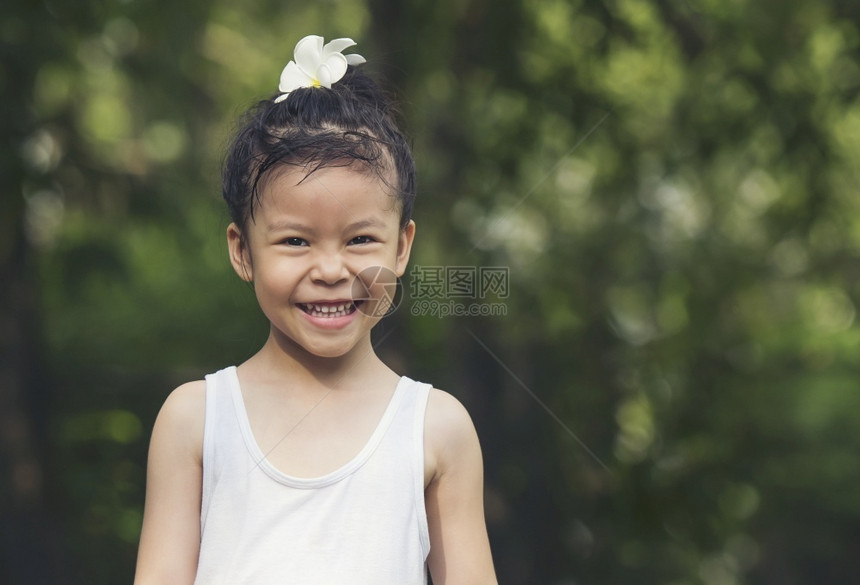 自然快乐的小女孩黑冰雪白西装花在头上公园欢乐的笑容趣后代图片
