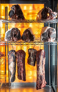 切割牛肉挂在一个干燥的年老牛肉柜里排成一生的餐厅图片
