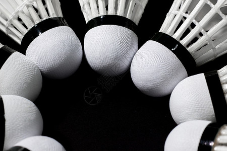 玩斗争黑背景的羽毛球锦标赛中的飞梭孔雀竞赛图片