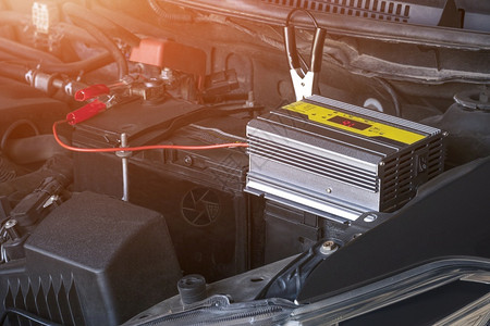 维护便携的红色用式电池充器和汽车发动机上的跨接电缆为汽车池充图片