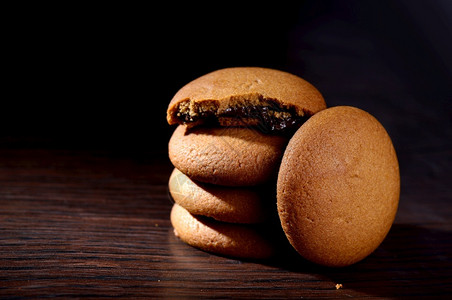巧克力奶油饼干棕色巧克力黑色背景奶油馅塞满食物覆盖图片
