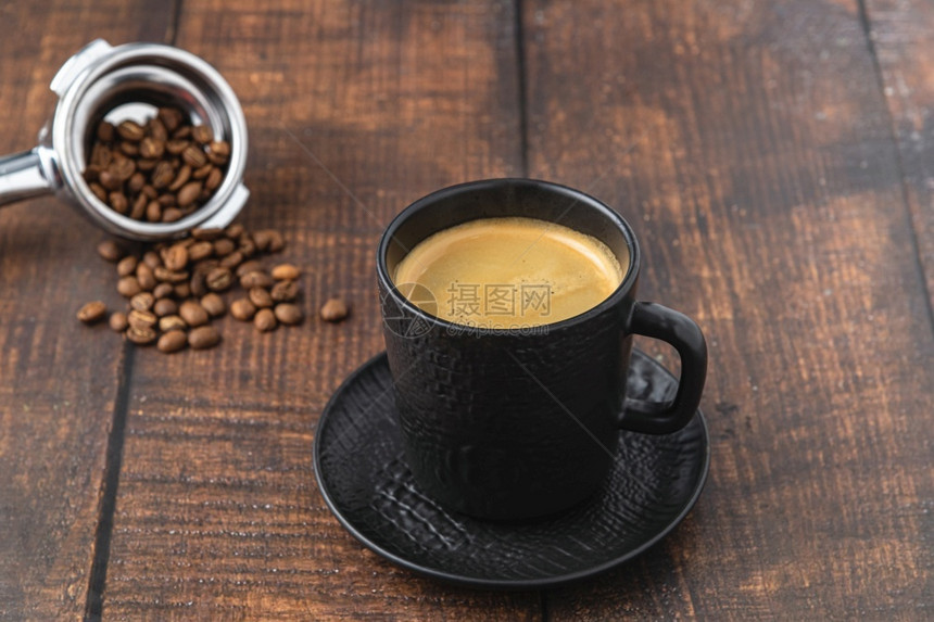 在木制桌上用黑色瓷杯子来放松美式咖啡商业棕色的早餐图片