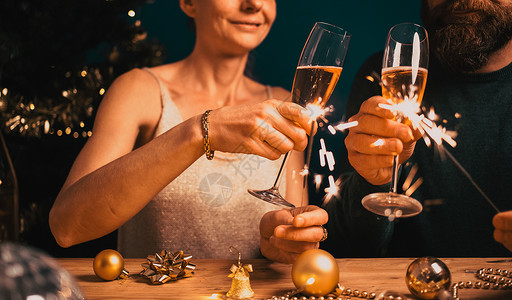 生日葡萄酒灯幸福的情侣拿着火花和香槟杯新年派对图片