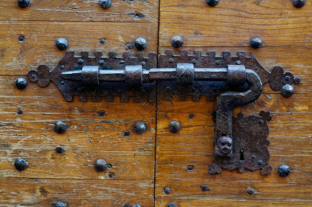 细节复古的老木制门用传统的铁制金属锁闭住古老的门用伪造金属锁闭铆钉图片