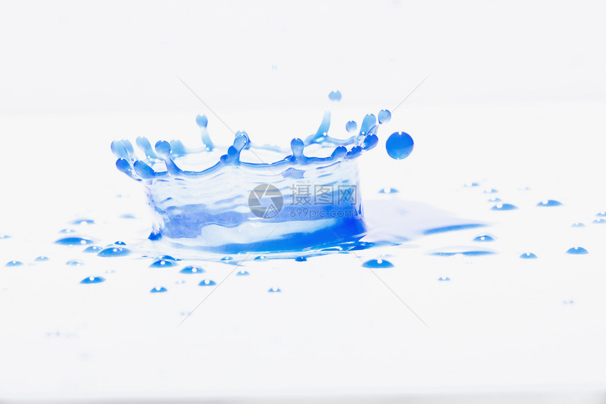 蓝水在白色背景下喷洒照片来自蓝色水上喷洒新鲜的颜色雨图片