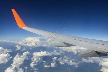 模糊一种航天蓝白云上飞行的机翼蓝天白云中飞行的机翼背景图片