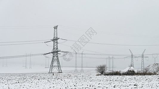 峰谷电价力量工程冬季风景中的高电压塔冬季雪价昂贵的供暖以及欧洲电价不断上涨等情况工业的背景