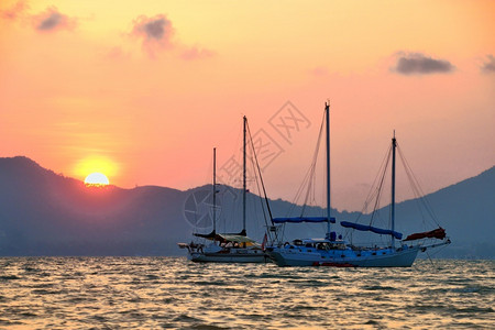 地平线海景暮色中游艇的剪影帆船图片