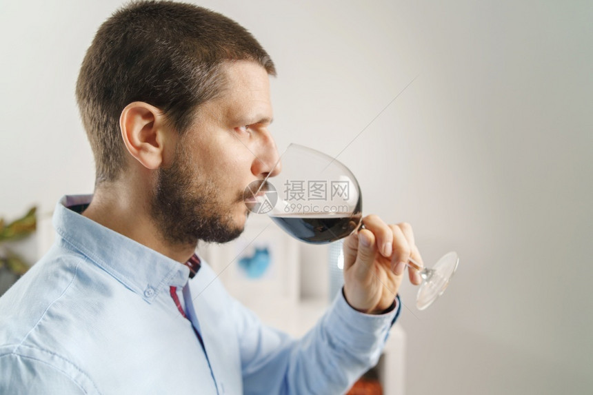 夜晚成年黑人男子穿着盛红酒杯的衬衫晚上或在家喝葡萄酒身着大胡子和短头发的男在家中紧闭独自的香气图片