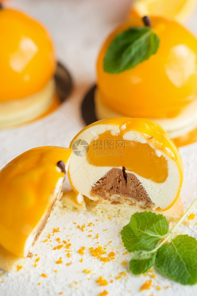 白色的美味夏天Mousse甜点橙色芝士和薄荷以橘子水果蛋糕形状的Mousse甜点图片