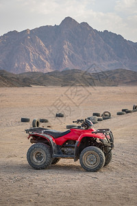 户外ATVQuadBike在沙漠和背景的美丽石山冒险自行车图片