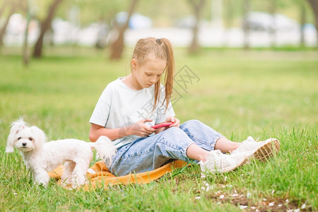 在公园和狗狗休息的小女孩图片