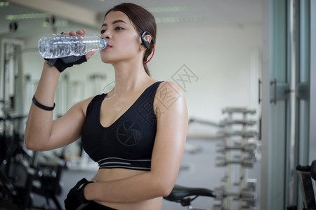 在健身锻炼后运动妇女作为的饮用水健康概念快乐的毛巾白种人图片