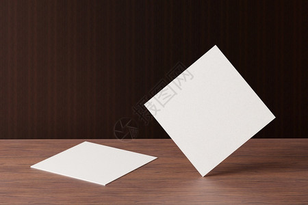 公司文档木头在棕色桌背景上用白方形纸商务卡模型制作木棕色桌背景的品牌展示模板打印图形设计2张卡模拟3D插图背景图片