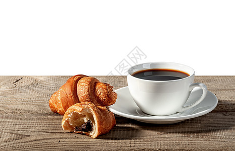 木头小吃饮料咖啡和在木制桌上的羊角面包破碎的牛角面包图片