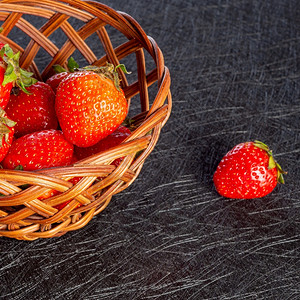 美味的深色背景中带新鲜草莓的篮子黑色背景中篮子收获的草莓团体浆果图片
