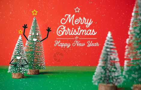 跳舞的圣诞新年快乐圣诞新年有一棵树微笑着脸的Xmas树在绿色桌上装饰充满情感涂鸦风格的装饰鲜红色和下雪背景喜庆贺卡通片季节红色的设计图片