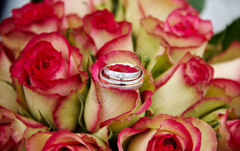 粉色的已婚女士带有玫瑰和戒指的婚礼花束图片