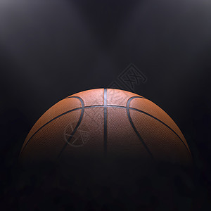 活动篮球在黑色背景与聚光灯的Bokoh橙运动图片