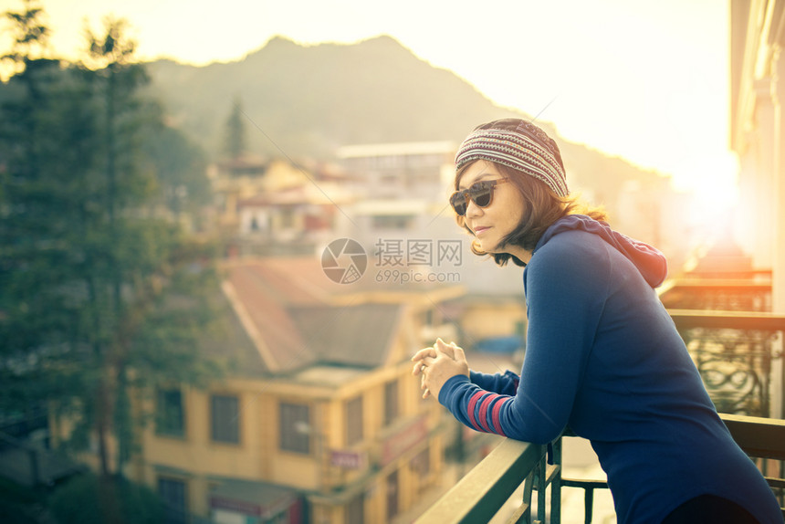 假期站在建筑露台外的年轻旅行女青看着美丽的太阳升起目地景色等待着美的到来吸引人家图片
