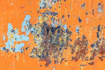 蜕皮质地铁风化橙色金属背景有破碎剥皮涂料含蓝油漆和生锈点的污渍设计图片