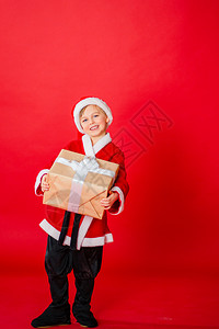 抱着圣诞礼物盒的小男孩图片