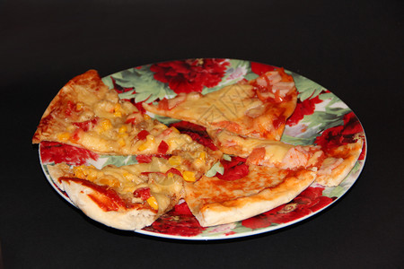 彩片素材快速地拼盘新鲜开胃披萨片黑色背景上的彩盘子有美味的配料披萨在黑色背景上隔离的盘子煮熟快餐意大利菜新鲜的开胃披萨片彩色盘子上有美味背景
