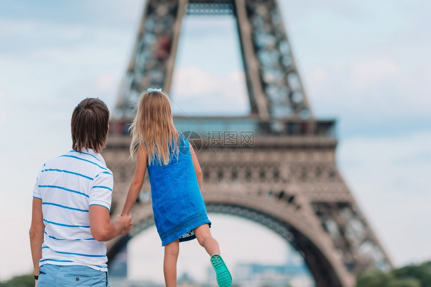 靠近在巴黎度假的法庭背景EiffelTower小可爱女孩和她父亲在巴黎埃菲尔塔附近的巴黎她夏天在法国度假时的父亲和小可爱女孩旅行图片