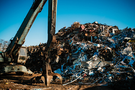 碎装有工作起重机和深蓝天空的金属垃圾场生锈的城市景观图片