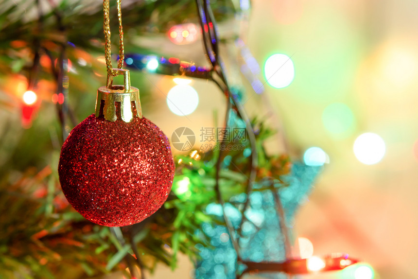 庆祝将红色闪亮球挂在松树枝上圣诞园和装饰品悬挂在带有复制空间的抽象bokeh背景上木制的绿色图片