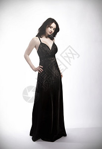 身穿黑衣服的年轻美女站立黑色的时髦地奢华图片