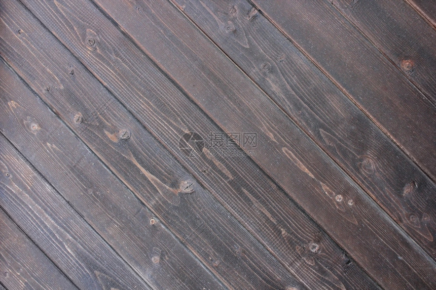 简单粗糙的用于设计纹理的黑色木地板不均匀的图片