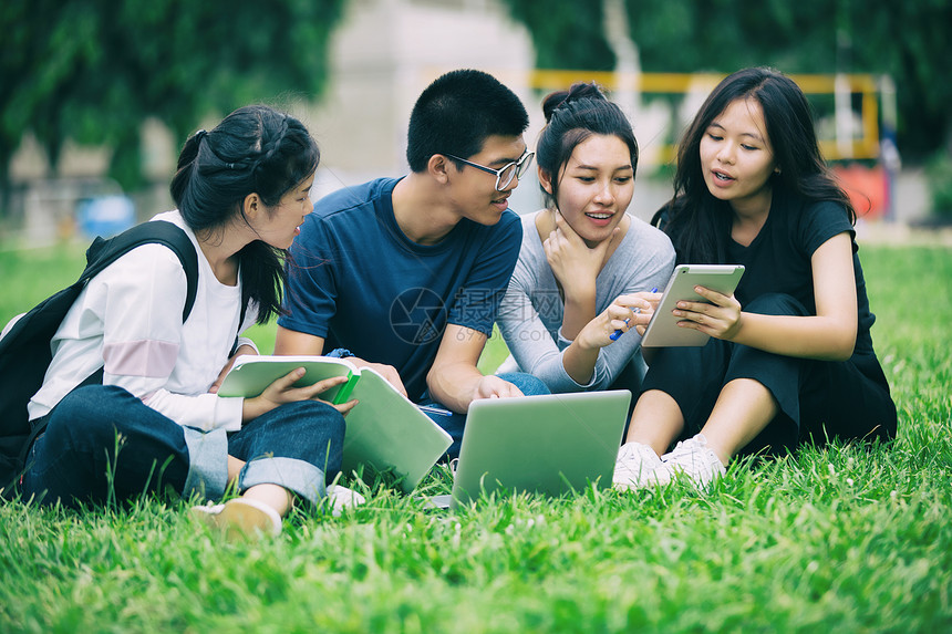 亚洲学生们在户外草坪上一起分享想法图片