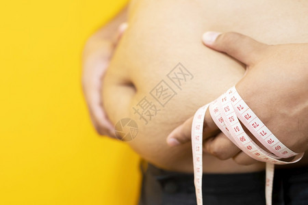 健康胃触碰肥胖男子想通过每天的锻炼来减肥控制食物图片