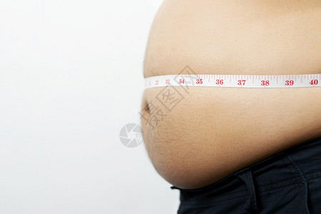 肥胖男子想通过每天的锻炼来减肥控制食物保持健康图片
