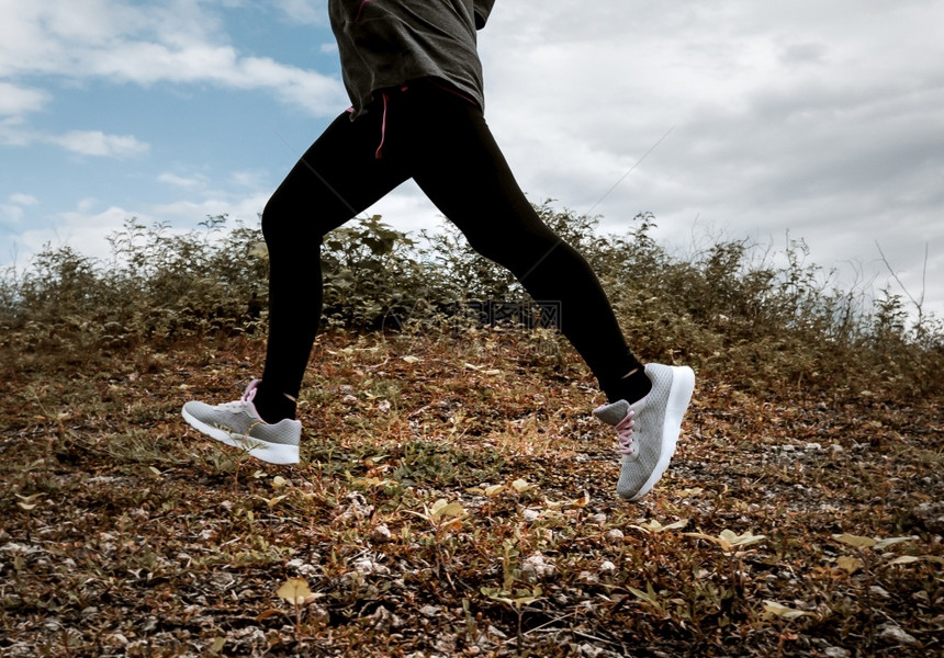 跑步女运动者在早上锻炼运动中自然行的女动者健康生活方式概念用跑鞋合腿的近式健康生活方式概念动户外图片