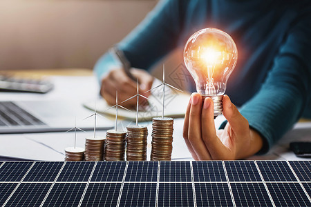 太阳能led感应灯灵感力量金融的拥有硬币涡轮和太阳能电池板概念节省能源和财务会计的灯泡带有硬币涡轮的女商人设计图片