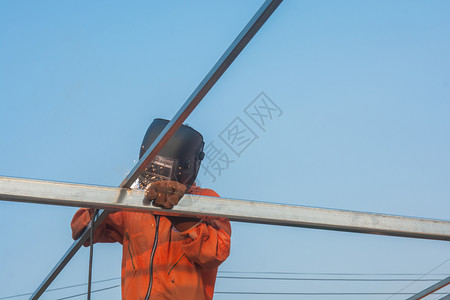 在职的将工人焊接在橙色作服中焊接业的热图片
