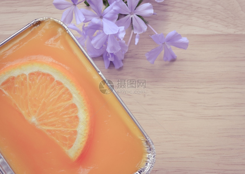 橙色软蛋糕在木本底的铝粉盘中用橘子水果切成橙可口片甜点图片