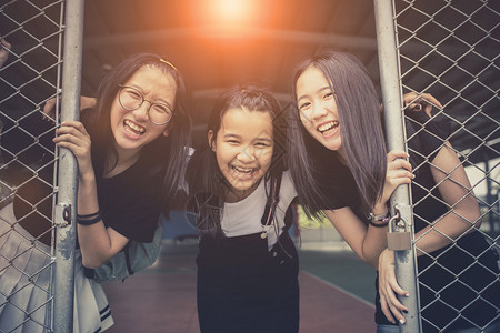 享受学校体育场里的亚裔青少年快乐情绪的表团体派对图片