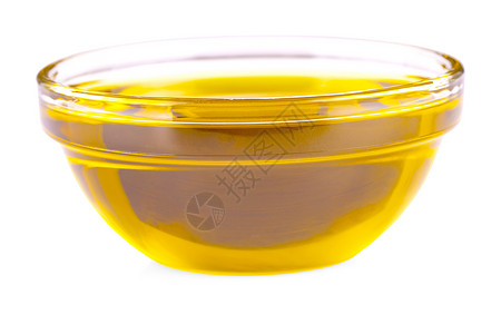 敷料向烹饪油喷洒一个白色背景孤立的小玻璃杯处女厨房图片