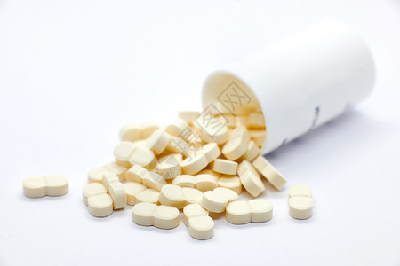 维他命抗生素育力白色背景上从瓶子里出来的药丸高清图片