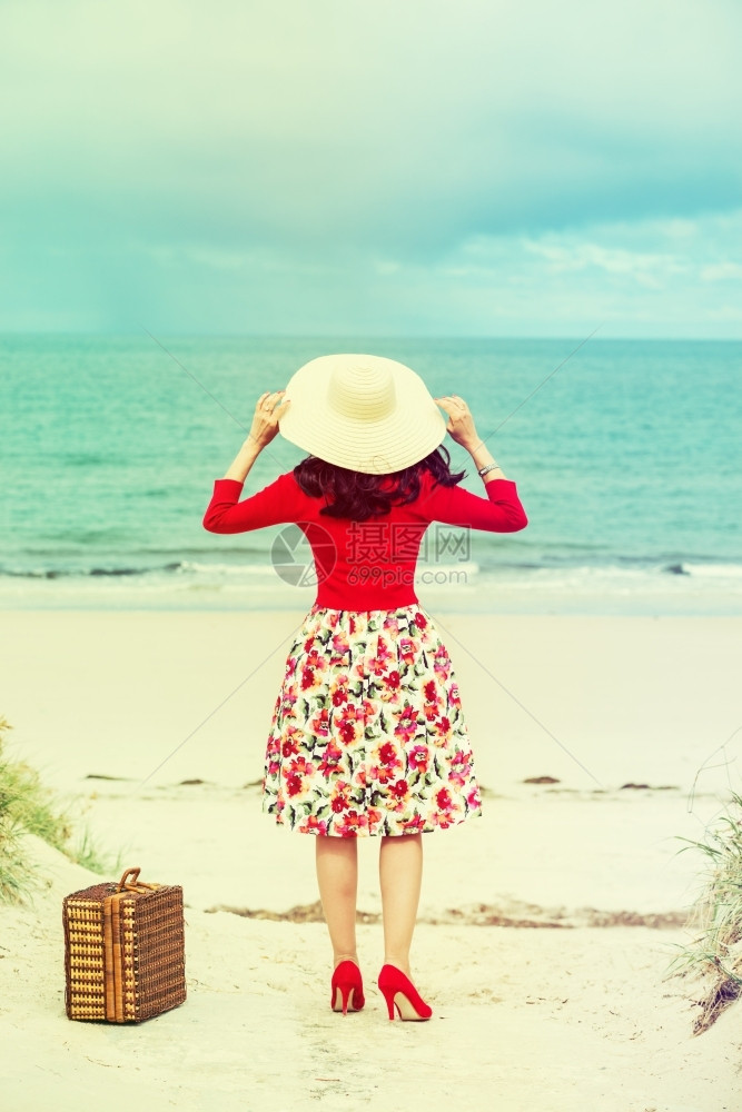 假期旅游优质的在海滩上穿旧式礼服的漂亮女旅行者图片