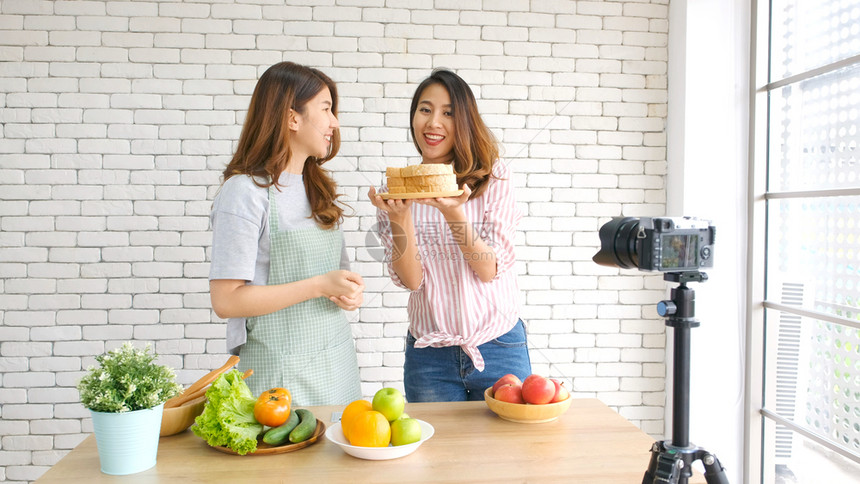 两位年轻的青女食物博客在录制视频时交谈与快乐刻vlog概念人与科技通讯等美食蔬菜人们图片